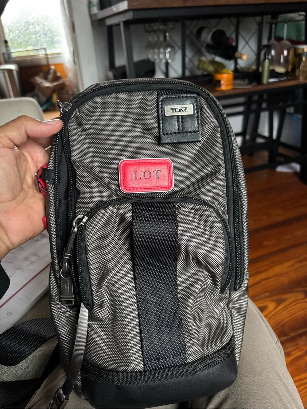 Tumi FIFE Gray SLIM Sling Bag dark grey and black.